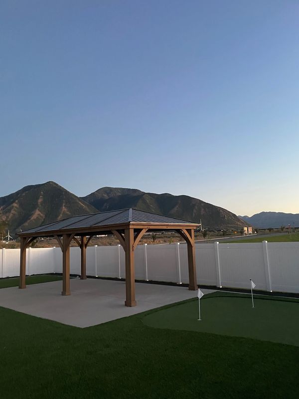 Yardistry 12x20 gazebo on concrete by turf putting green in Spanish Fork, Utah
