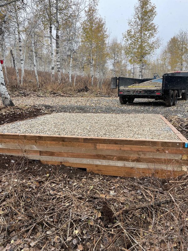 Gravel pad with timber retaining wall in mountains in Huntsville, Utah in the snow