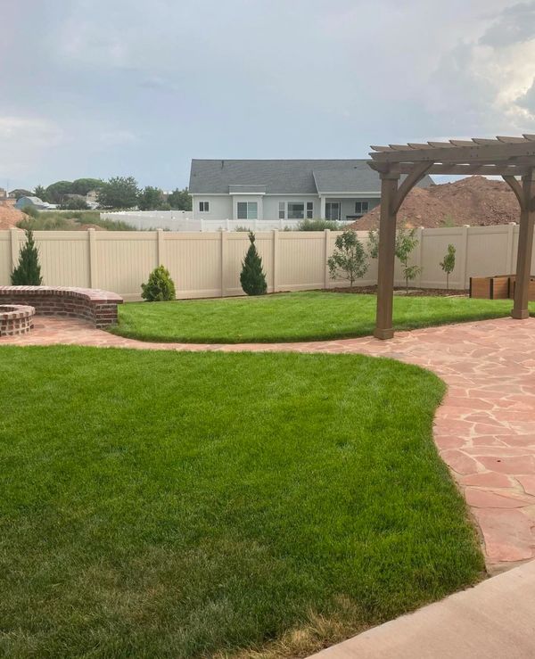 Yardistry 12x12 pergola on flagstone patio next to garden boxes and brick firepit in Clearfield, UT