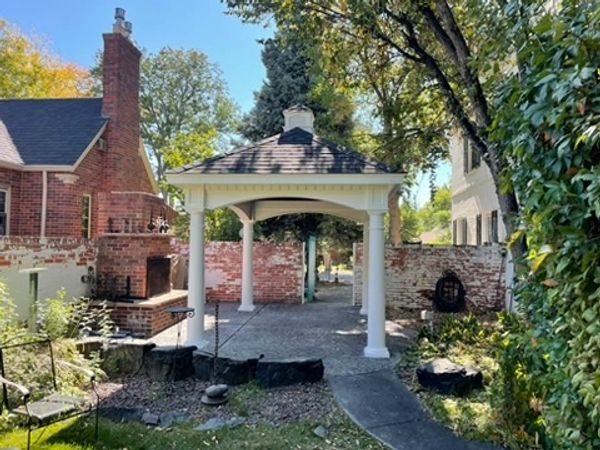 CountryLane Gazebos Grand Estate Pavilion in front of brick fireplace in Cheyenne, Wyoming