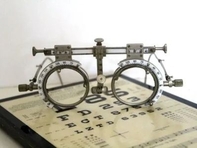 An optometry trial frame on an eye chart.