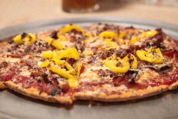 Freshly baked pizza topped with mushrooms and banana peppers at Urbana Brewing Co.