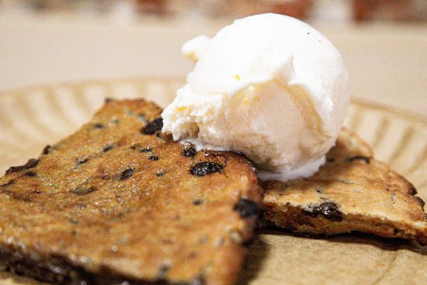 Chocolate chip dessert bread topped with vanilla ice cream on a plate at Urbana Brewing Co.