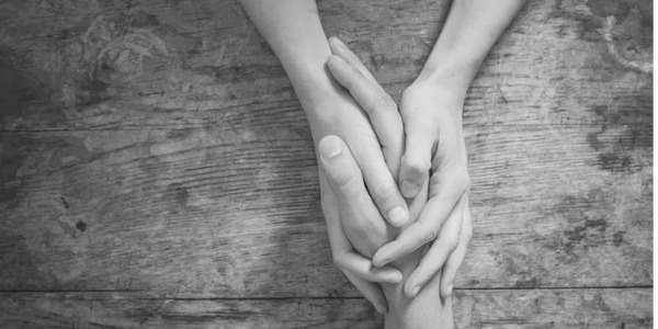 Empathy and support in a non-judgemental way, holding hands. Empathy in therapy.