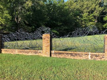 Private commission for steel fence panels to fit within existing brick fence.