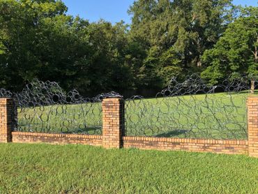 Private commission for steel fence panels to fit within existing brick fence.