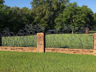 Private commission for steel fence panels to fit within existing brick fence.