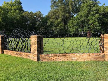 Private commission for steel fence panels to fit within existing brick fence.