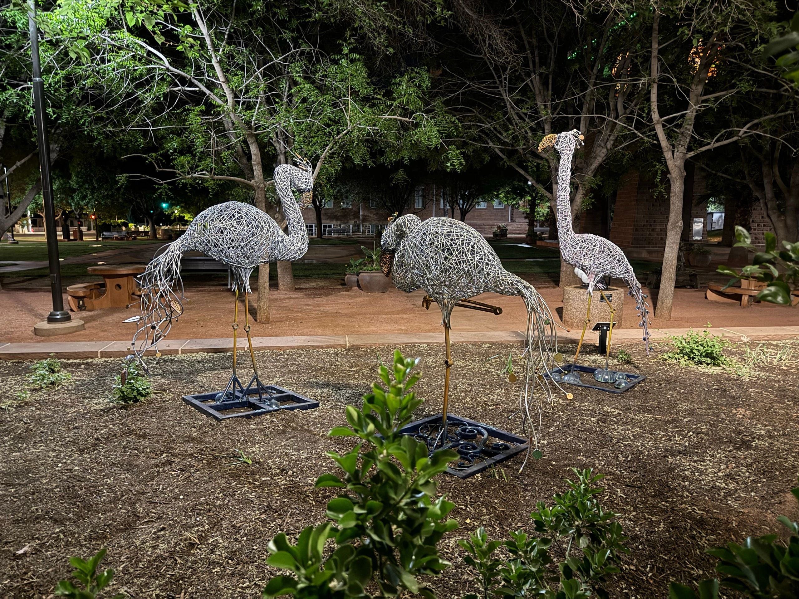 Group of steel water birds at night. 