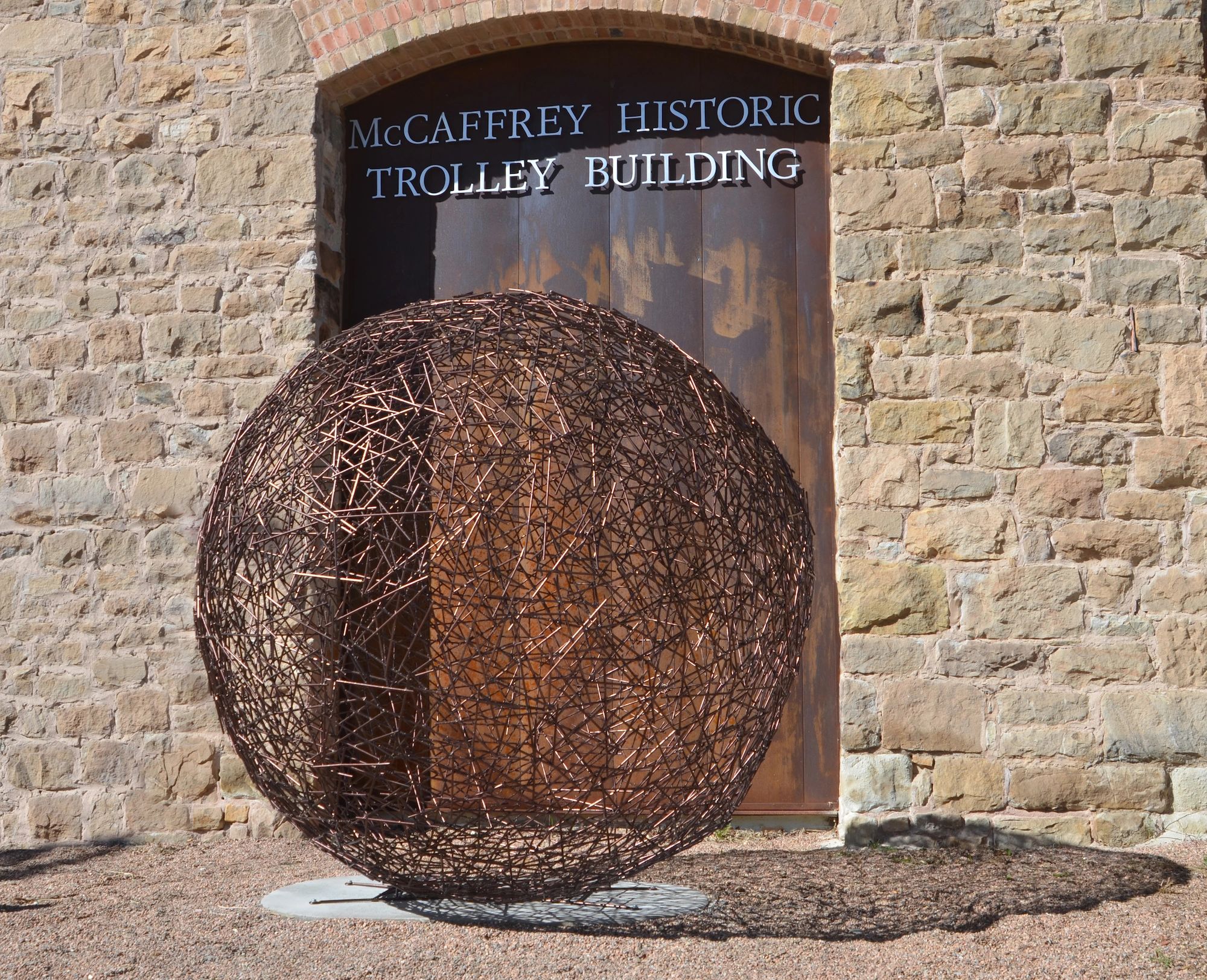 "Do You See What I See" is a powder coated steel spherical sculpture.