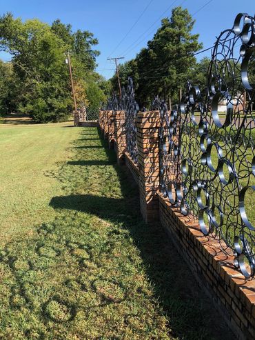 Private commission for steel fence panels to fit within existing brick fence.