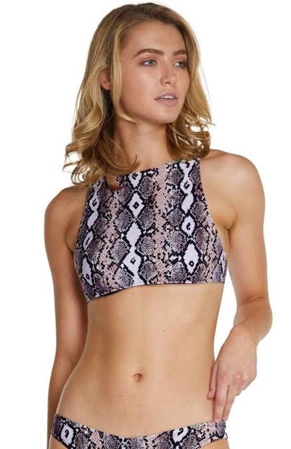 Model wearing crop top featuring a snakeskin animal print