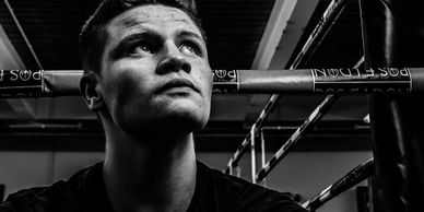 Poseidon boxing club member sitting on the side of the boxing ring