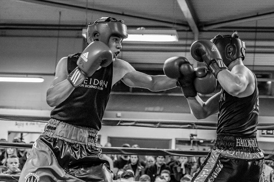 An action shot of Poseidon boxer, Taylor Bevan, in a competitive bout