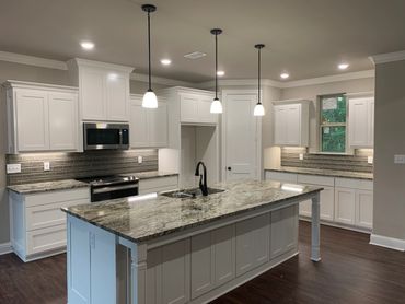 Custom kitchen. Granite countertops. kitchen lighting. Stainless steel appliances. kitchen island.