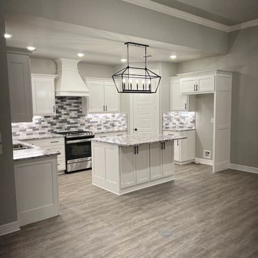 Custom kitchen. Granite countertops. kitchen lighting. Stainless steel appliances.