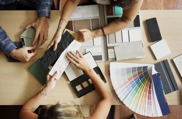 People selecting materials and colors for a design project.