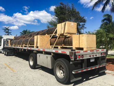 Drilling Pipes transported on a flat bed truck.