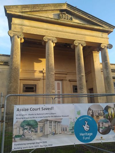 Devizes Assize Court behind court rails. the rails feature a banner that states Assize Court Saved.