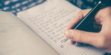 Open Notebook with a person making a checklist