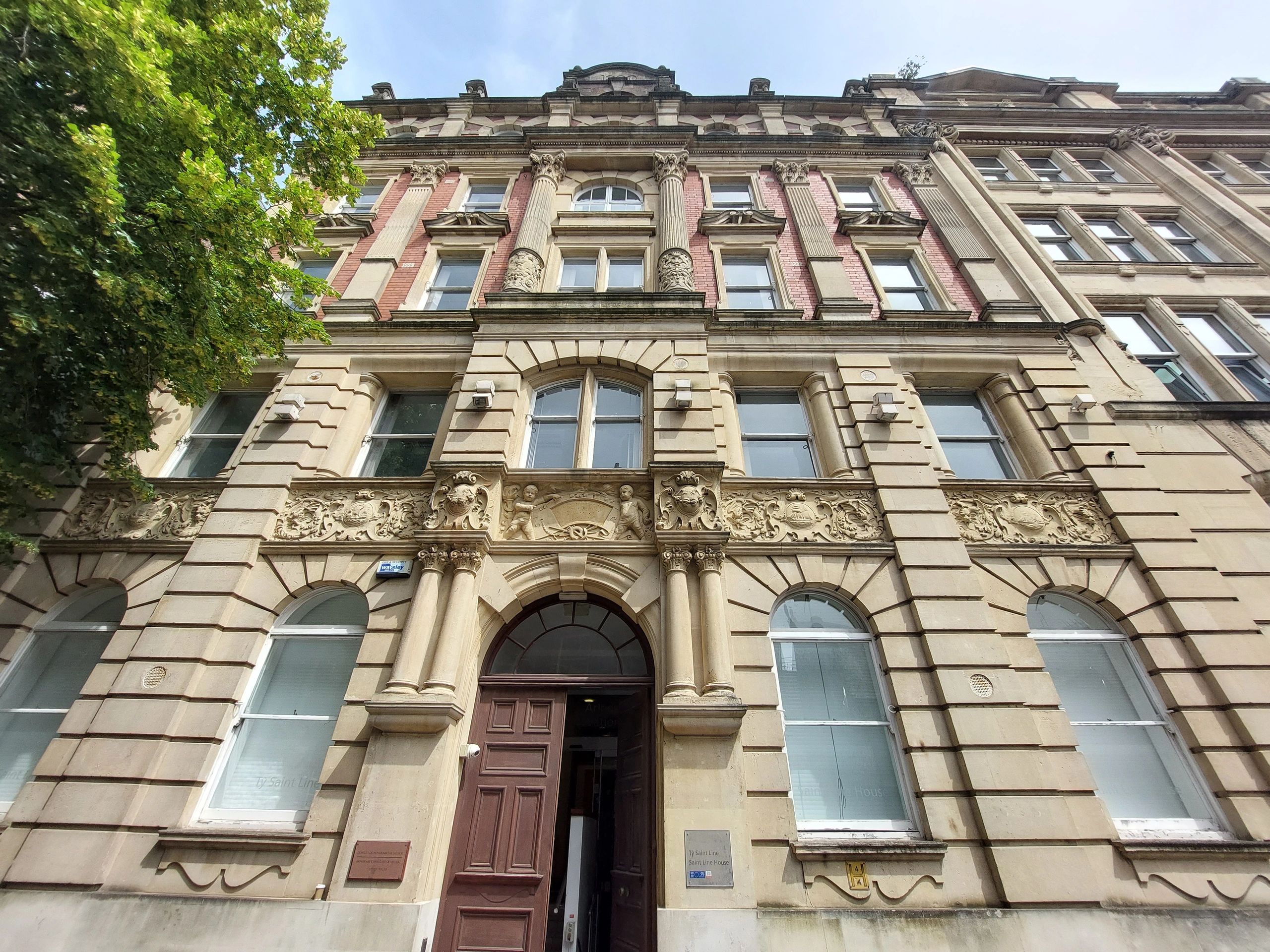 Historic building facade with detailed stone carvings and columns.