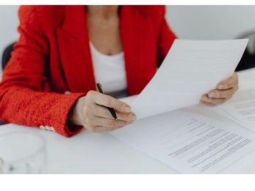 Person reviewing documents at a desk.