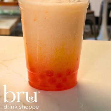 Orange bubble tea with tapioca pearls.