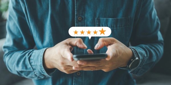 Man selecting 5 stars option on his phone