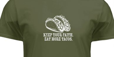 Olive green t-shirt with two tacos and the phrase "Keep Your Faith. Eat More Tacos."