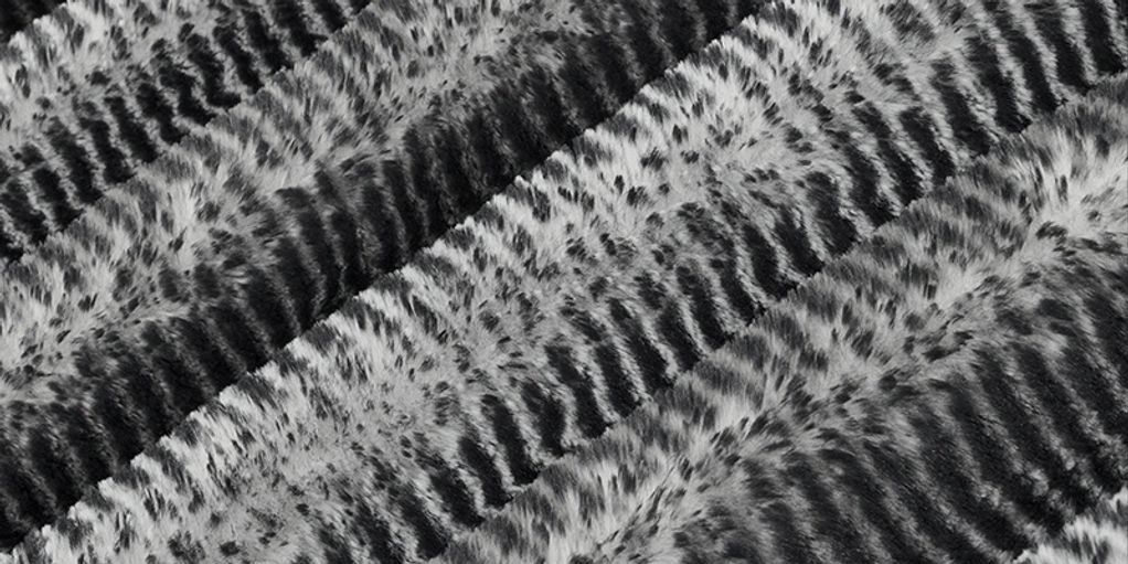 Close-up of textured fabric with a black and white zigzag pattern.