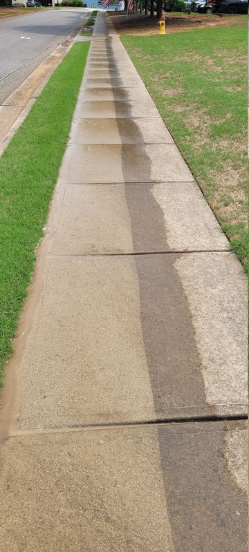 Half-cleaned concrete sidewalk shows contrast.