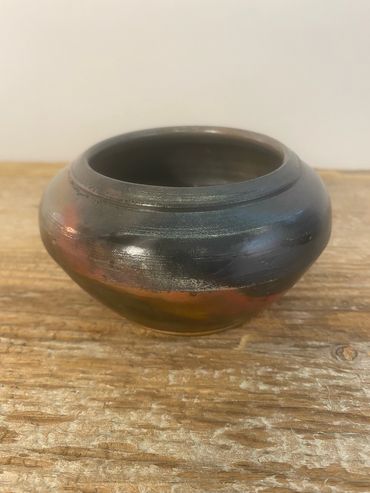 A studio shot of a pit fired pot.