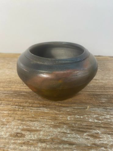 A studio image of a pit fired pot