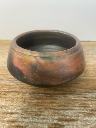 A studio shot of a Raku type of pot.