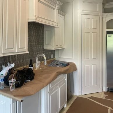 Kitchen under renovation with covered countertops.