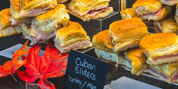 Tray of Cuban sliders with turkey and ham.