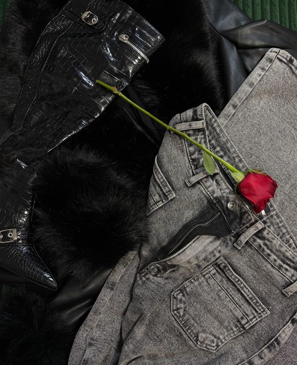 Gray jeans, black faux fur coat, and a single red rose.