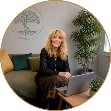 Fiona in her therapy room with laptop for online counselling