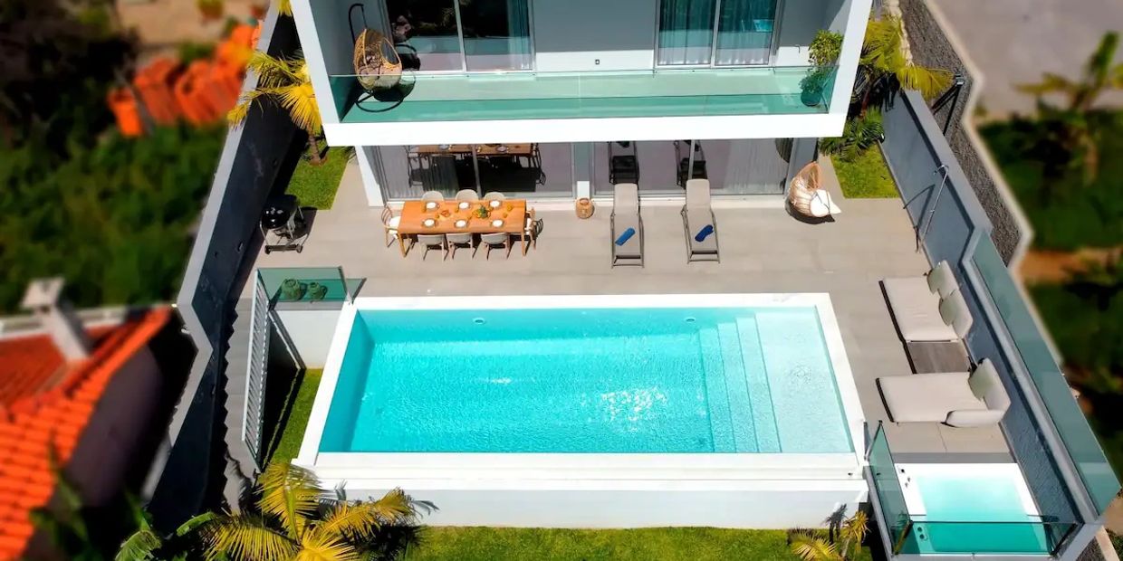 Villa Obra-Prima seen from above showing balcony, terrace, infinity pool, and jacuzzi