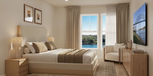 Minimalist bedroom with neutral tones and a waterfront view.