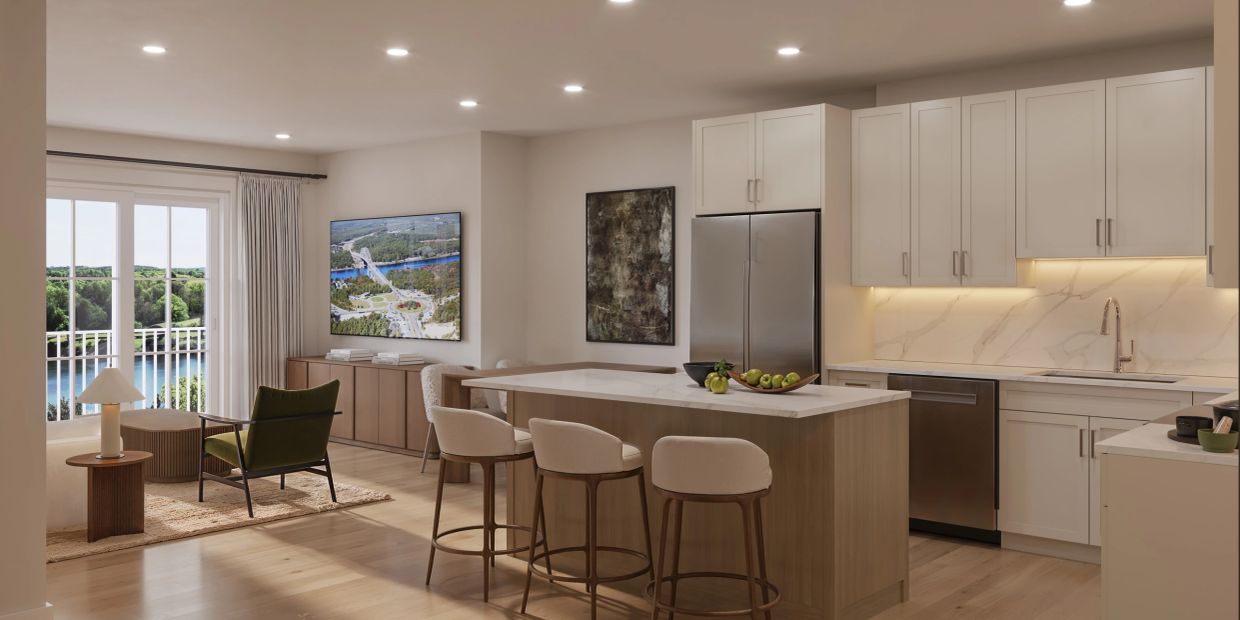 Modern kitchen and living area with water view and minimalist decor.