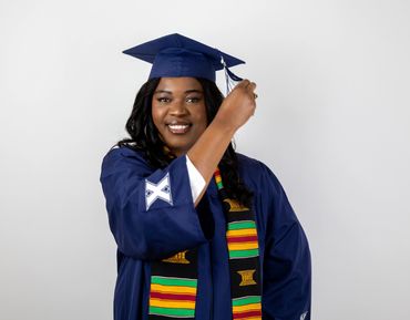 A woman poses in Cap and Gown from Xavier College of Nursing