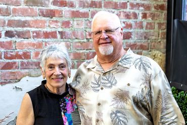 A man and woman celebrating their 50th wedding anniversary pose for the camera. 