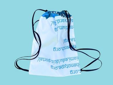 White drawstring bag with blue text on a light blue background.
