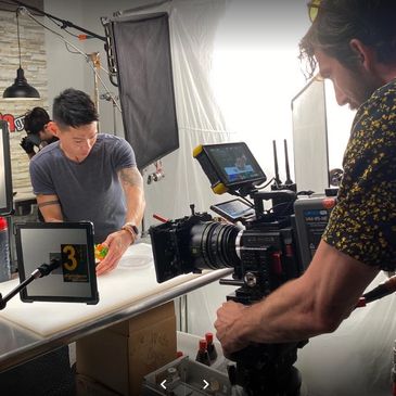 Camera man filming a food item