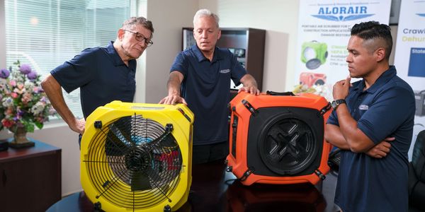 Group of employees in a conference room discussing air purifier machines. 