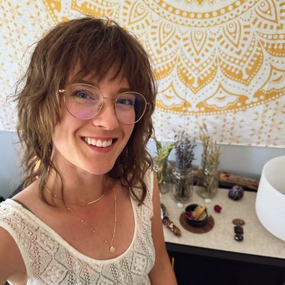 An energy healer, intuitive reader & relaxation therapist displays a welcoming smile
