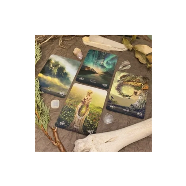 Intuitive readings are done with these oracle cards laying on a table with herbs and bones
