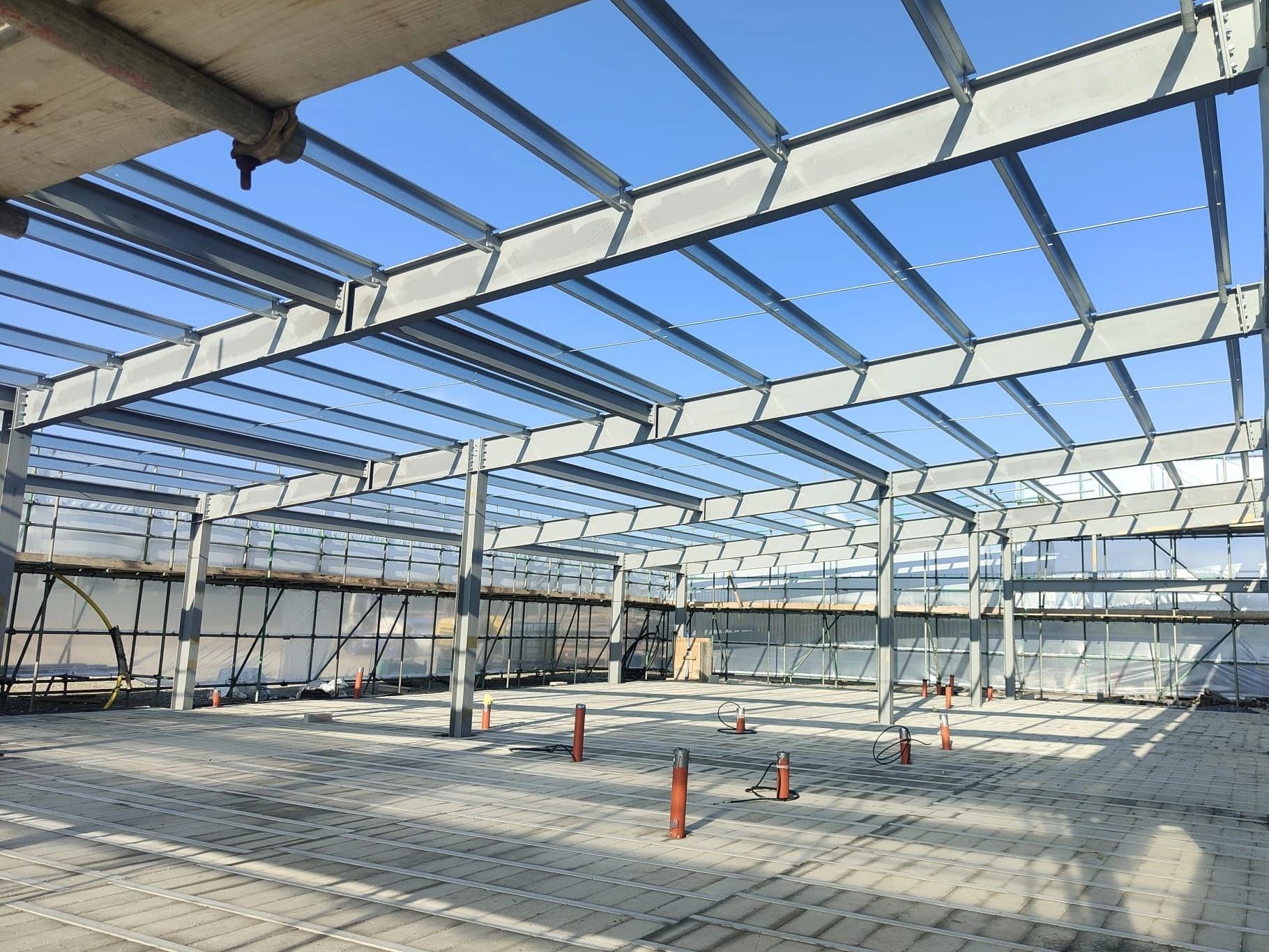 Structural steel at a new industrial building prepped and finished with an intumescent coating 