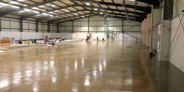 Polished industrial resin floor in warehouse space. 